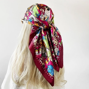 Detail of colorful cartoon cat print on a 90cm satin square headscarf worn as a headpiece