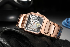 Close-up of rose gold mechanical watch featuring a skeleton dial and gear details