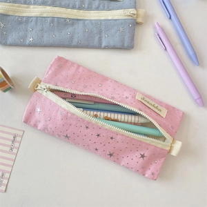 Detail of pink canvas star pouch with Sozakka brand tag and smooth zipper closure