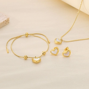 Detailed view of a gold shell heart jewelry set with necklace, bracelet, and earrings