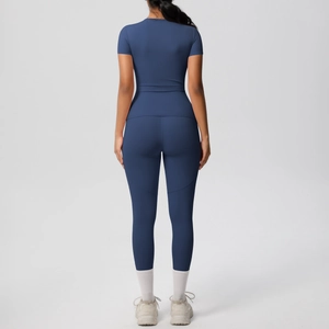 Detail of navy yoga set showing slim fit short sleeve top and high waist leggings