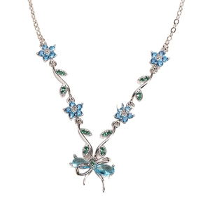 Silver necklace with blue flower and green leaf gemstones on a white background