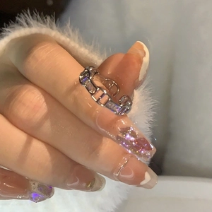 Adjustable silver butterfly ring with rectangular zircon stones on a model's finger