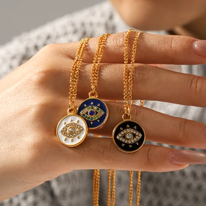 Gold Evil Eye pendant necklaces in white, blue, and black enamel with rhinestones