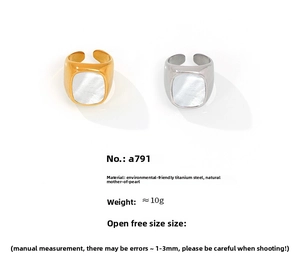 Detail view of gold and silver titanium steel rings with white mother of pearl inlay