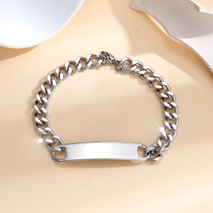 Detailed view of silver stainless steel Cuban chain bracelet with rectangular blank ID tag