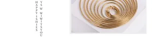 Detailed macro view of gold-plated titanium steel hoop earrings with fine threaded texture