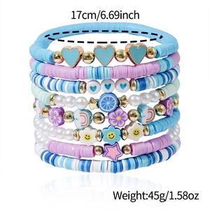 Detail showing stacked colorful Bohemian clay bead bracelets with pearls and smile charms