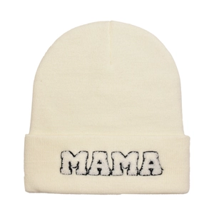 Detailed macro view of the thick knitted texture and MAMA embroidery on the cream beanie