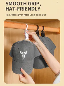 Detail of a plastic rotating laundry clip on a wooden rod for hat and glove storage