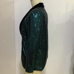 Detail of dark green sequin blazer with black velvet lapel and shimmering texture