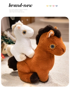 Detail of plush horse set featuring a brown mother horse and a white foal with sun embroidery