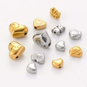 Macro detail of baroque style heart-shaped LOVE beads in gold and silver finish