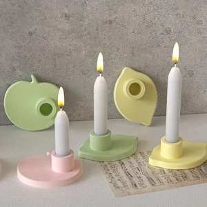 Macro shot of macaron colored leaf and apple shaped candle holders with matte resin finish
