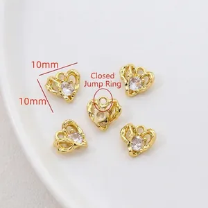 Detail of five 10mm gold heart pendants with cubic zirconia and closed loops for DIY