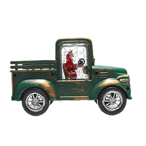 Close-up of vintage green Christmas truck lantern featuring Santa in a water snow globe