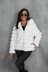 Detail of white faux fur hooded jacket featuring thick plush texture and metal zipper