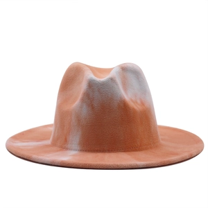 Detailed texture of orange and white tie-dye wool felt fedora with a flat brim design