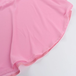 Detailed view of pink chiffon dress featuring ruffle hem and fine stitching craftsmanship
