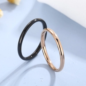 2mm thin stainless steel minimalist rings in black and rose gold on a blue background