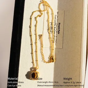 Vintage gold square pendant necklace with tiger eye stone on elegant white display box
