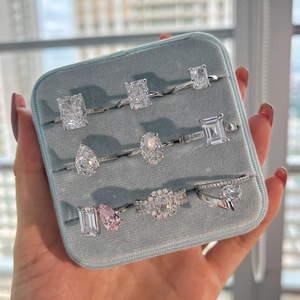 Detail view of luxury S925 silver rings with ice flower cut zircons in blue velvet box