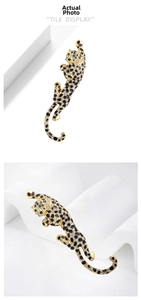 Detail of leopard brooch with white rhinestones, black enamel spots and green eyes