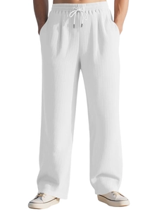 Close-up of white pleated wide-leg trousers with vertical texture and drawstring waist