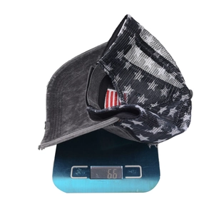 Distressed washed baseball cap with American flag embroidery on a weighing scale