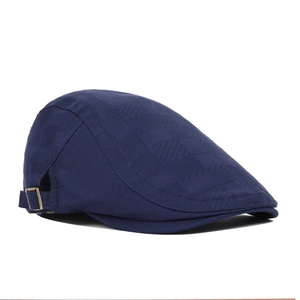 Navy blue newsboy cap with subtle check pattern and adjustable metal buckle