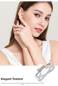 Close-up of S925 sterling silver X-shaped ring showing D0.40 engraving and sparkling zircons