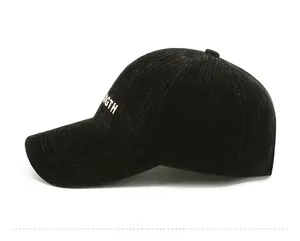 Close-up of black corduroy baseball cap with white STRENGTH side embroidery detail