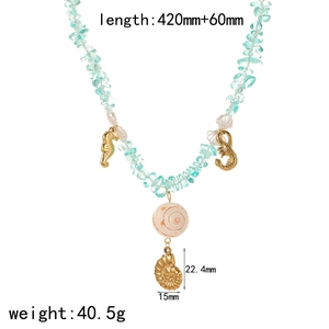 Natural stone bead necklace with golden seahorse and shell charms on white background
