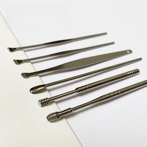 Macro view of 6-piece stainless steel earwax removal kit with spiral and spring cleaners