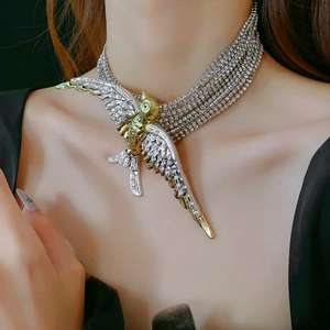 Macro shot of layered bird necklace with sparkling crystal rhinestones and mixed metal finish