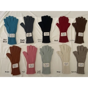 Flat lay of wool knit long gloves in ten diverse colors including blue, red and pink