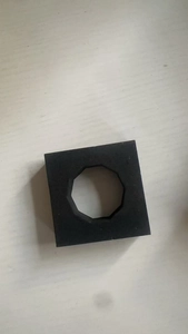 Detail of a black square foam pad with an octagonal cutout for shockproof packaging