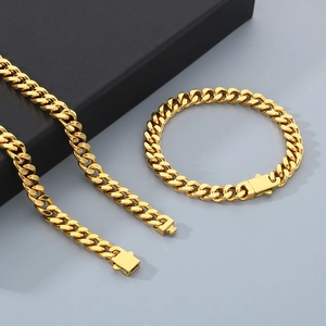 Close-up of golden Miami Cuban link chain necklace and bracelet set with gift box
