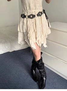 Y2K punk style white tiered floral skirt paired with a black metal ring studded belt