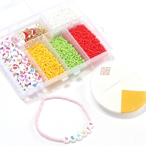 Detail of DIY jewelry kit with colorful beads, letter charms, and 0.6mm elastic cord