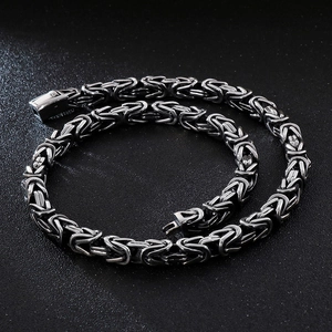 Polished silver stainless steel Byzantine chain necklace for men on black background