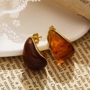 Macro view of amber resin water drop earrings with vintage 18k gold plated metal borders