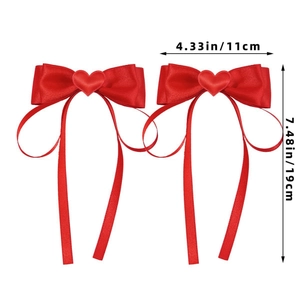 Detail of red satin bow hair clips with heart accent and dimensions 11cm by 19cm