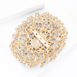 Detailed back view of gold-tone alloy brooch with textured metal finish and pin fastener
