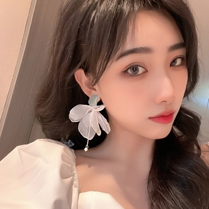 Elegant white organza flower bow earrings with long tassel pendant for a resort look