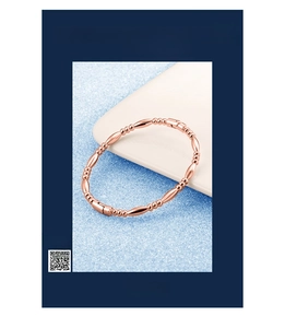 Detailed close-up of rose gold beaded bracelet with smooth oval metal beads and polished finish