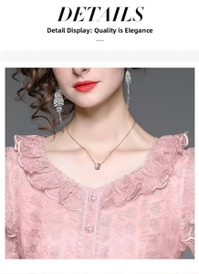 Detailed close-up of pink lace embroidery and layered ruffle neckline on summer dress