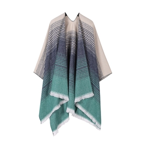 Detail of a knit shawl with beige, navy, and green stripes and fringe trim