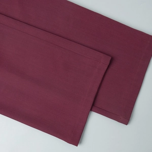 Detail shot of burgundy trousers hem with premium double-stitch sewing on woven fabric