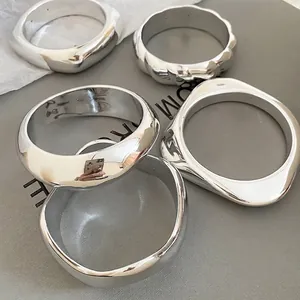 Polished silver geometric bangle set with irregular wavy and thick minimalist designs